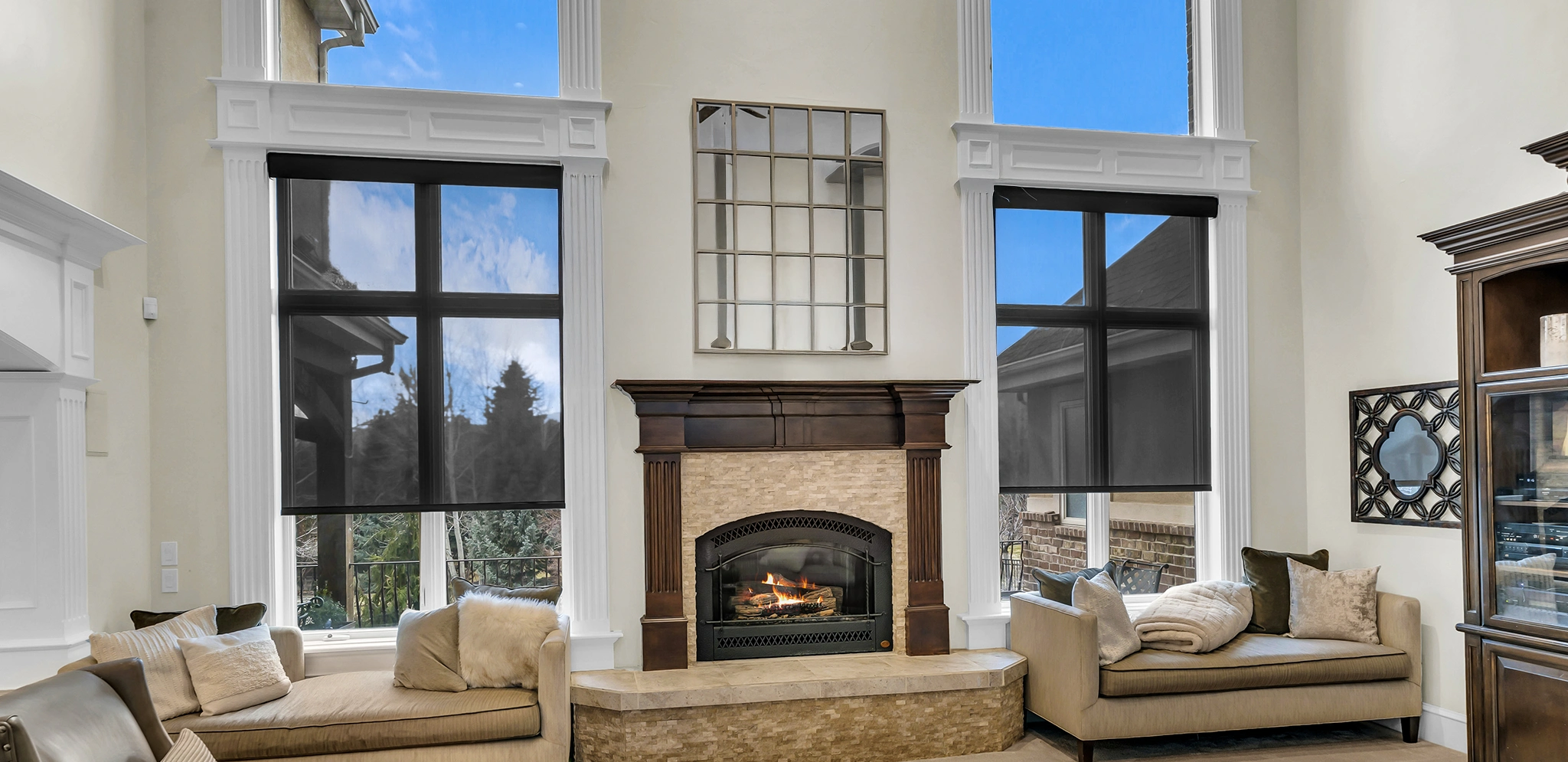 black roller shades in a large living room area